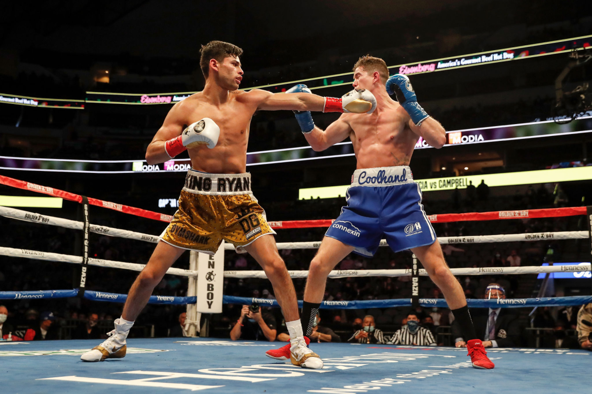Ryan Garcia, left, throws a punch against Luke Campbell during their WBC lightweight title fight Jan. 2, 2021.