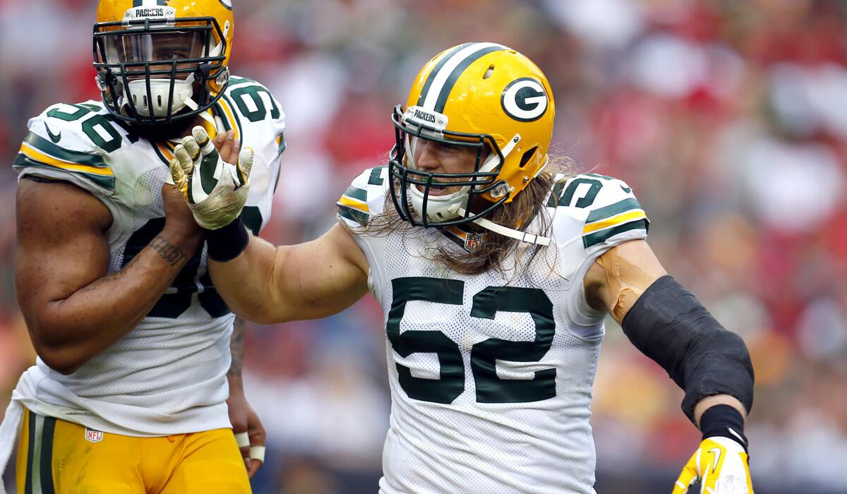 Packers linebacker Clay Matthews (52) is congratulated by teammate Julius Peppers after a sack against Tampa Bay on Dec. 21.