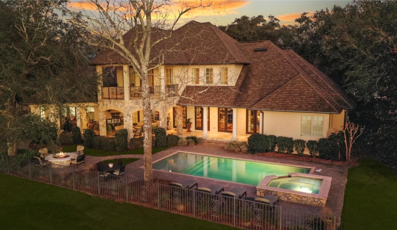 Built in 2011, the stone-clad home opens to an entertainer’s backyard and a private dock on Rocky Bayou.