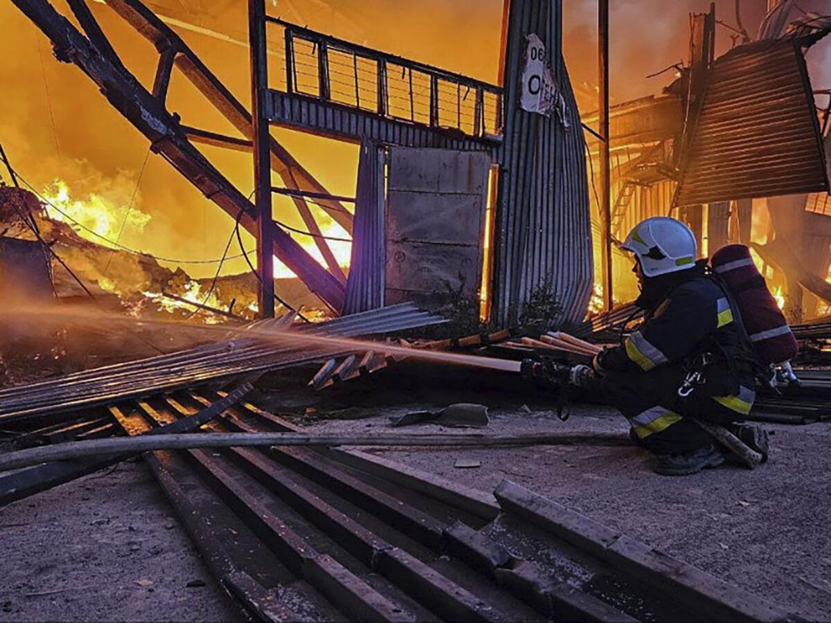 Emergency personnel battling a fire following a Russian attack in Lviv, Ukraine