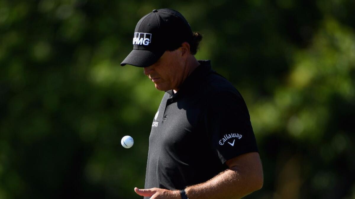 Phil Mickelson tosses a golf ball in the air on June 17, during the second round of the U.S. Open at Pennsylvania's Oakmont Country Club.