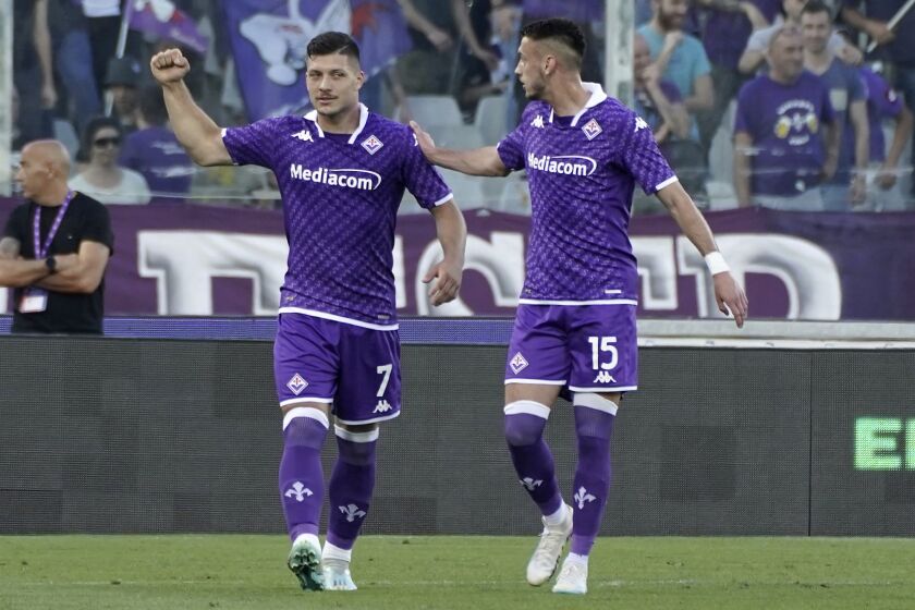 Fiorentina's Luka Jovic, left, celebrates after scoring his side's first goal during a Serie A soccer match between Fiorentina and Roma, at Florence's Artemio Franchi stadium, Italy, Saturday, May 27, 2023. (Marco Bucco/LaPresse via AP)