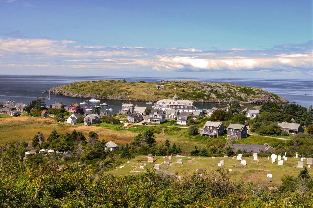 The populated area of Monhegan Island, Maine, with Manana Island and the Island Inn as viewed from the Lighthouse Hill.