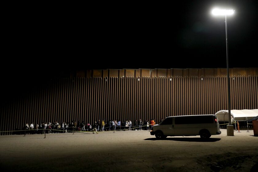 SOMERTON, AZ - MAY 11: Immigrants turn themselves over to U.S Border Patrol agents along the U.S.-Mexico border on Thursday, May 11, 2023 in Somerton, AZ. Title 42, a pandemic-era policy that allowed border agents to quickly turn back migrants, expires this week. Under a new rule, the U.S. on Thursday will begin denying asylum to migrants who show up at the U.S.-Mexico border without first applying online or seeking protection in a country they passed through. (Gary Coronado / Los Angeles Times)