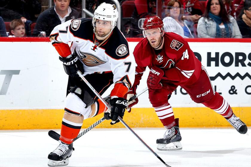 Anaheim's Andrew Cogliano shoots the puck in front of Arizona's Joe Vitale during the Ducks' 4-1 victory over the Coyotes on Tuesday.