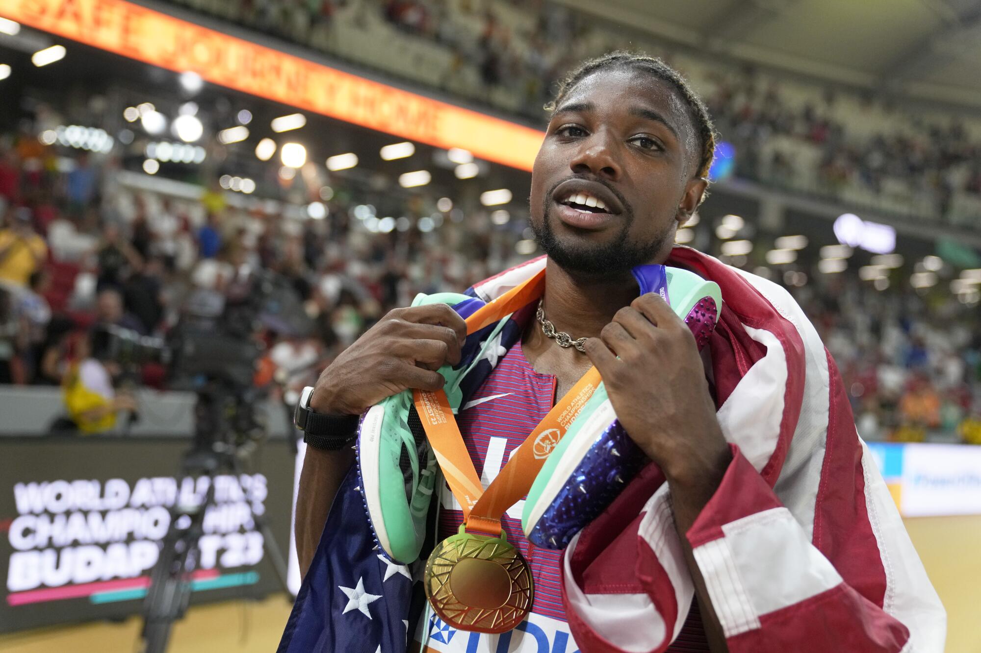 Noah Lyles celebrates with his gold medal after winning the men's 200 meters at the World Athletics Championships on Aug. 25.
