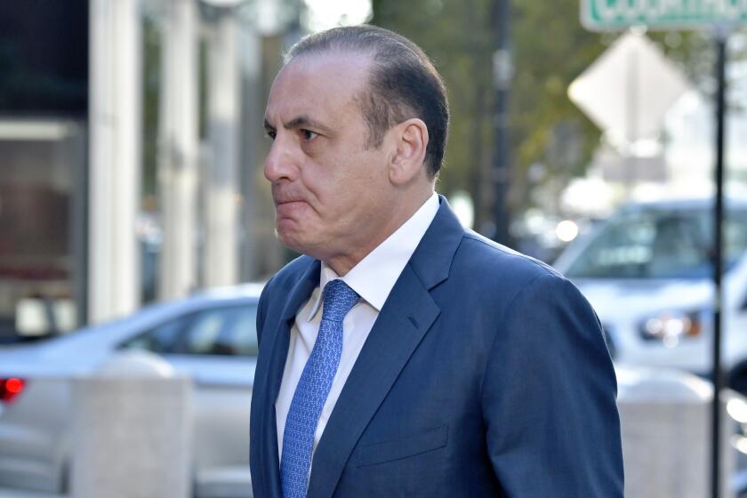 Gamal Abdelaziz arrives at federal court Thursday, Oct. 7, 2021, in Boston. Abdelaziz and another parent, John Wilson, are the first to stand trial in the college admissions bribery scandal, in which wealthy parents used lies and money to steal coveted spots at prestigious schools their kids couldn't secure on their own, according to a prosecutor.(AP Photo/Josh Reynolds)