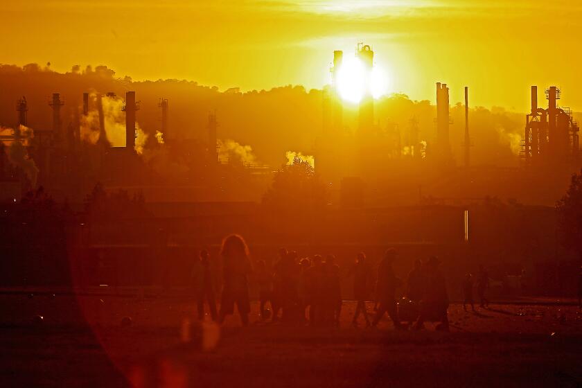 LOS ANGELES, CALIF. - OCT. 4, 2022. Youth soccer teams practice at Wilmington Waterfront Park in the shadow of the Conoco Phillips refinery. (Luis Sinco / Los Angeles Times)