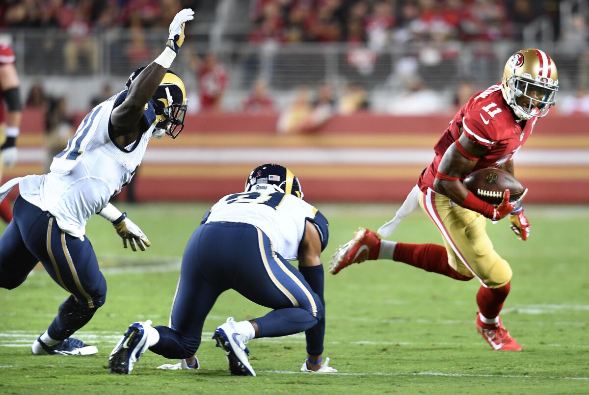 49ers receiver Quinton Patton eludes the tackle of Rams defenders Maurice Alexander, left, and Coty Sensabaugh for a huge gain in the fourth quarter.