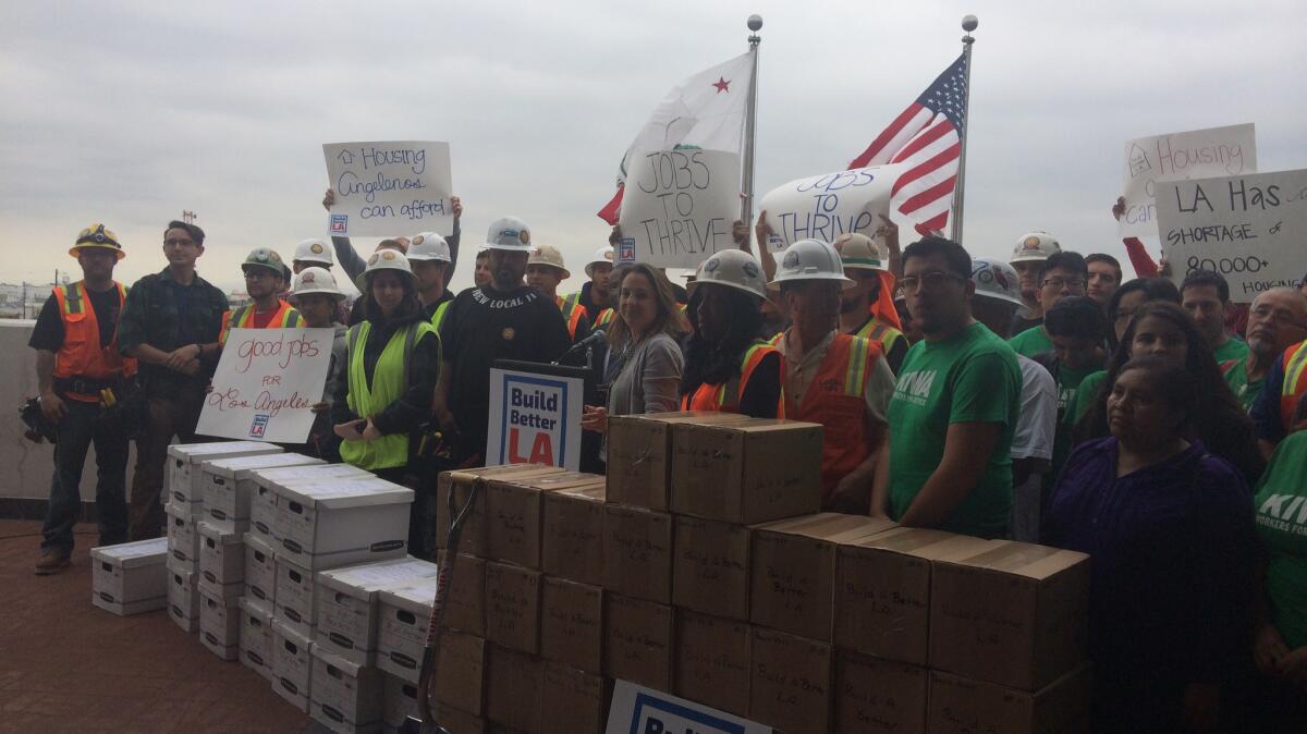Labor and housing activists deliver boxes of signed petitions for their proposed Build Better L.A. ballot measure to the Los Angeles City Clerk.