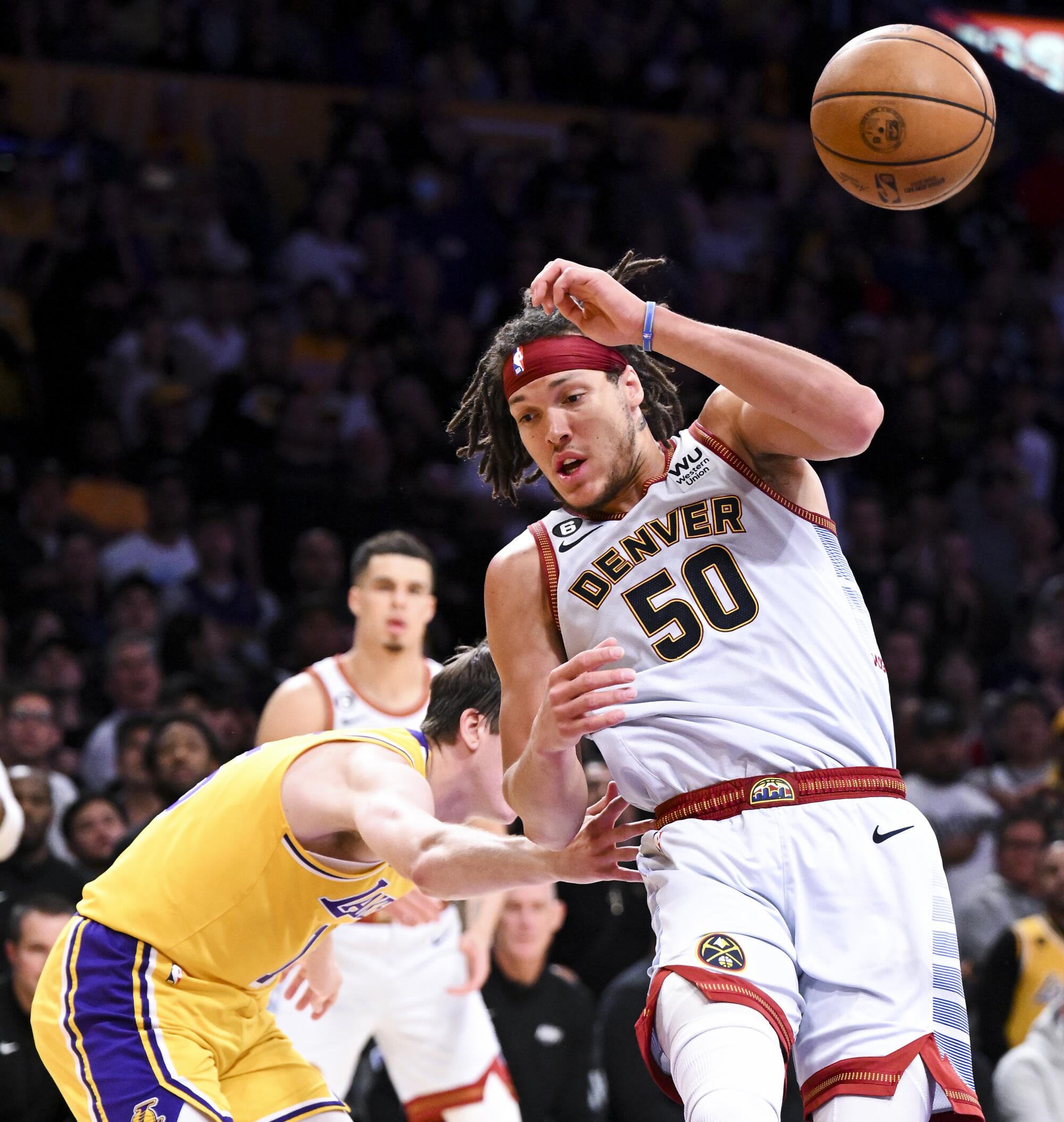 Lakers guard Austin Reaves fouls Nuggets forward Aaron Gordon during the fourth quarter.