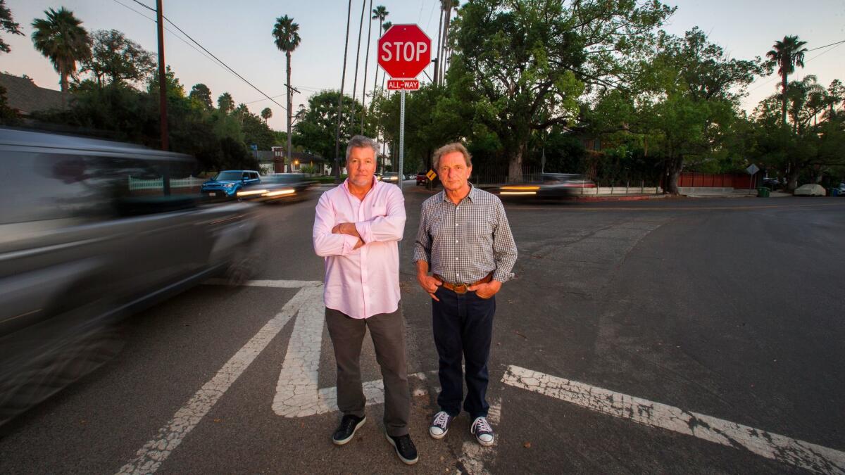 Rob Ramsey, left, and Alexander Von Wechmar spent 12 years pushing for a traffic circle at a dangerous intersection on their street. When the city said it didn't have the cash, they raised funds themselves.