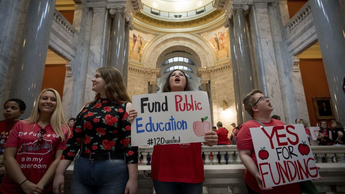 Teachers gather in the Kentucky state Capitol to call for increased function for education.