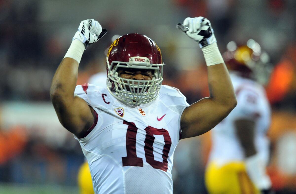 USC linebacker Hayes Pullard celebrates an interception in the Trojans' win over Oregon State. Pullard, a dynamic defensive player who's expected to explore the possibility of making himself available for the 2014 NFL draft, chose to attend USC over UCLA as a way to honor his father.