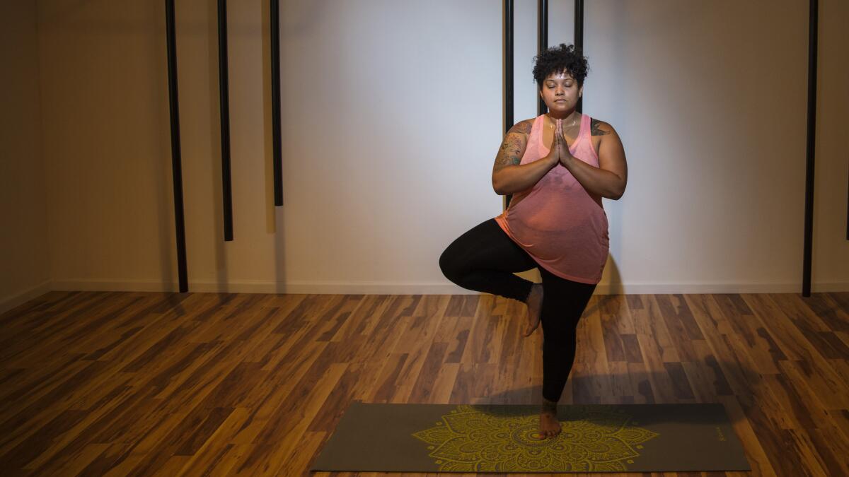 Yoga instructor and advisory board member Alli Simon, poses in the Rise Heal room at Everybody Gym.