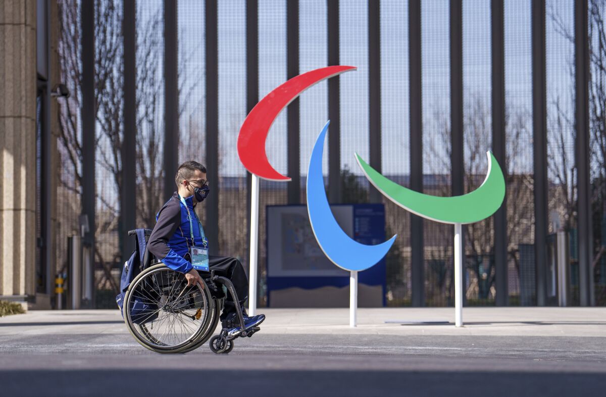 Italy's Matteo Remotti Martini moves in front of the Agitos outside the Paralympic Village ahead of the Beijing 2022 Winter Paralympic Games, Beijing, China, Thursday, March 3, 2022. (Thomas Lovelock/OIS via AP)