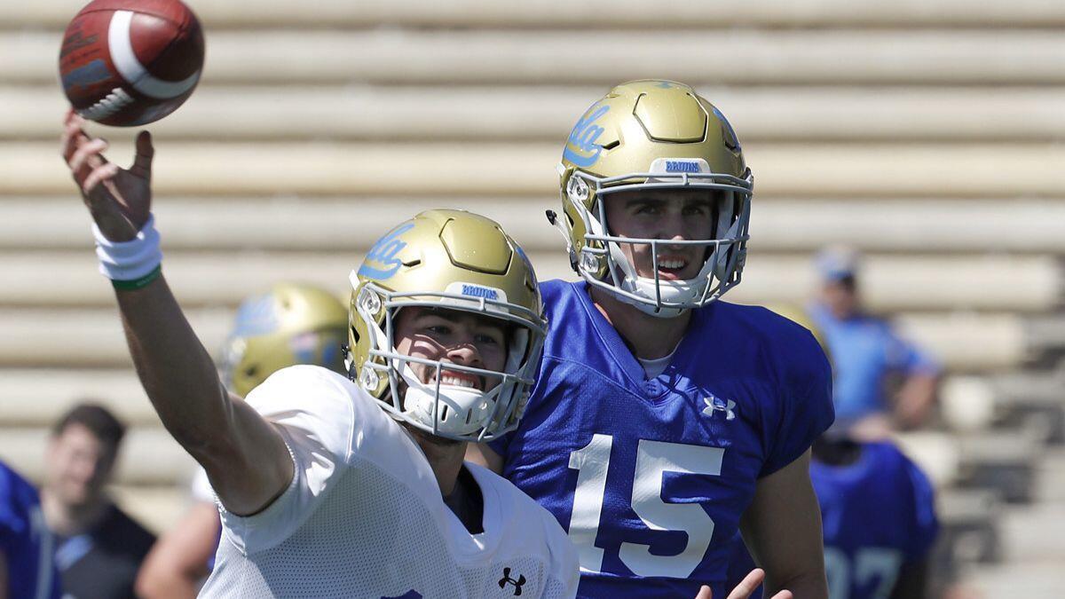 UCLA quarterbacks Jackson Gibbs (17) and Matt Lynch (15) warm up before the UCLA spring football game at Drake Stadium on April 21.