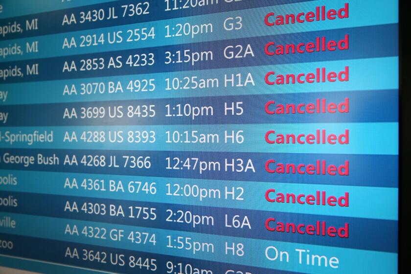 The arrival and departure display at O'Hare International Airport shows a list of cancelled flights on September 27, 2014