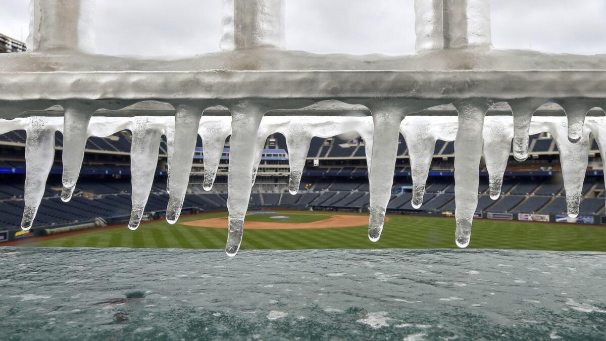 Ice forms on the railing above the fountains before a game between the Kansas City Royals and Angels on Sunday.