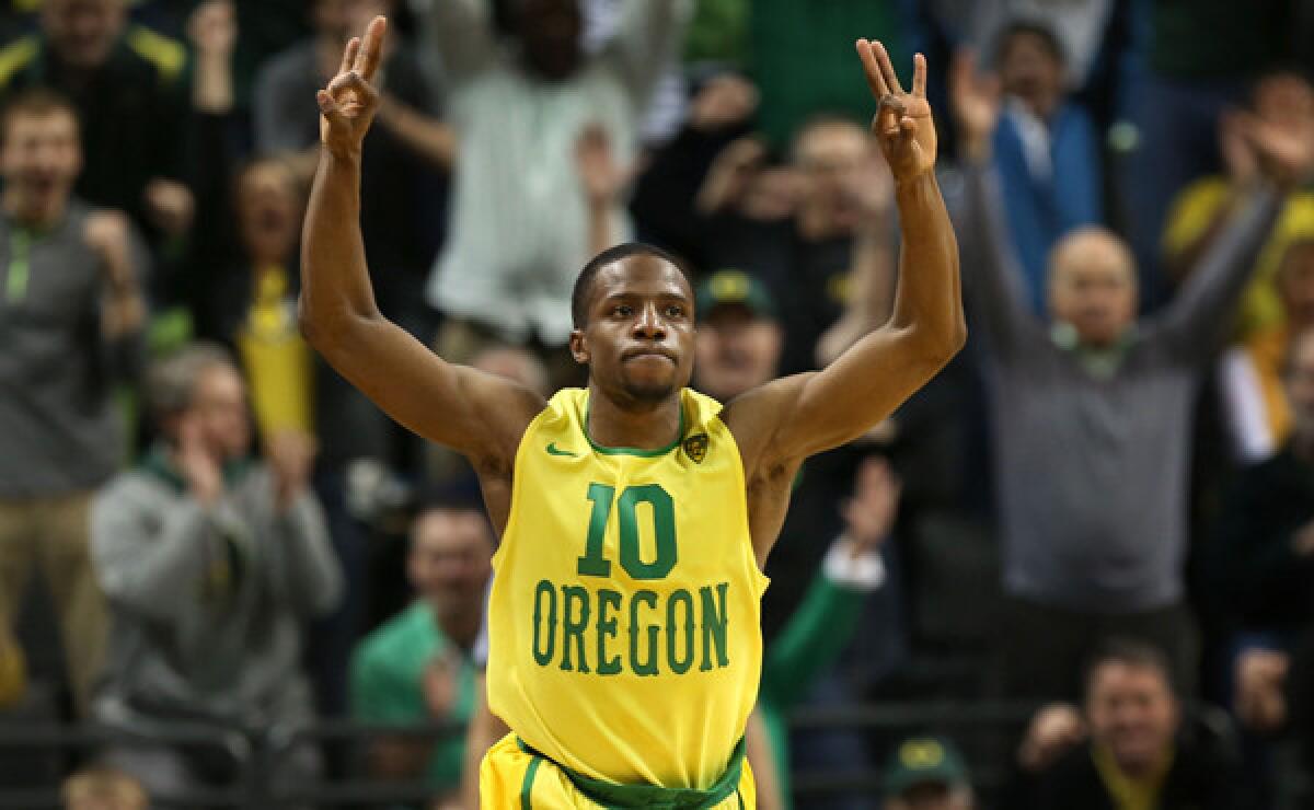 Oregon's Johnathan Loyd gestures after hitting a late three-pointer in the Ducks' 64-57 upset over Arizona on Saturday.