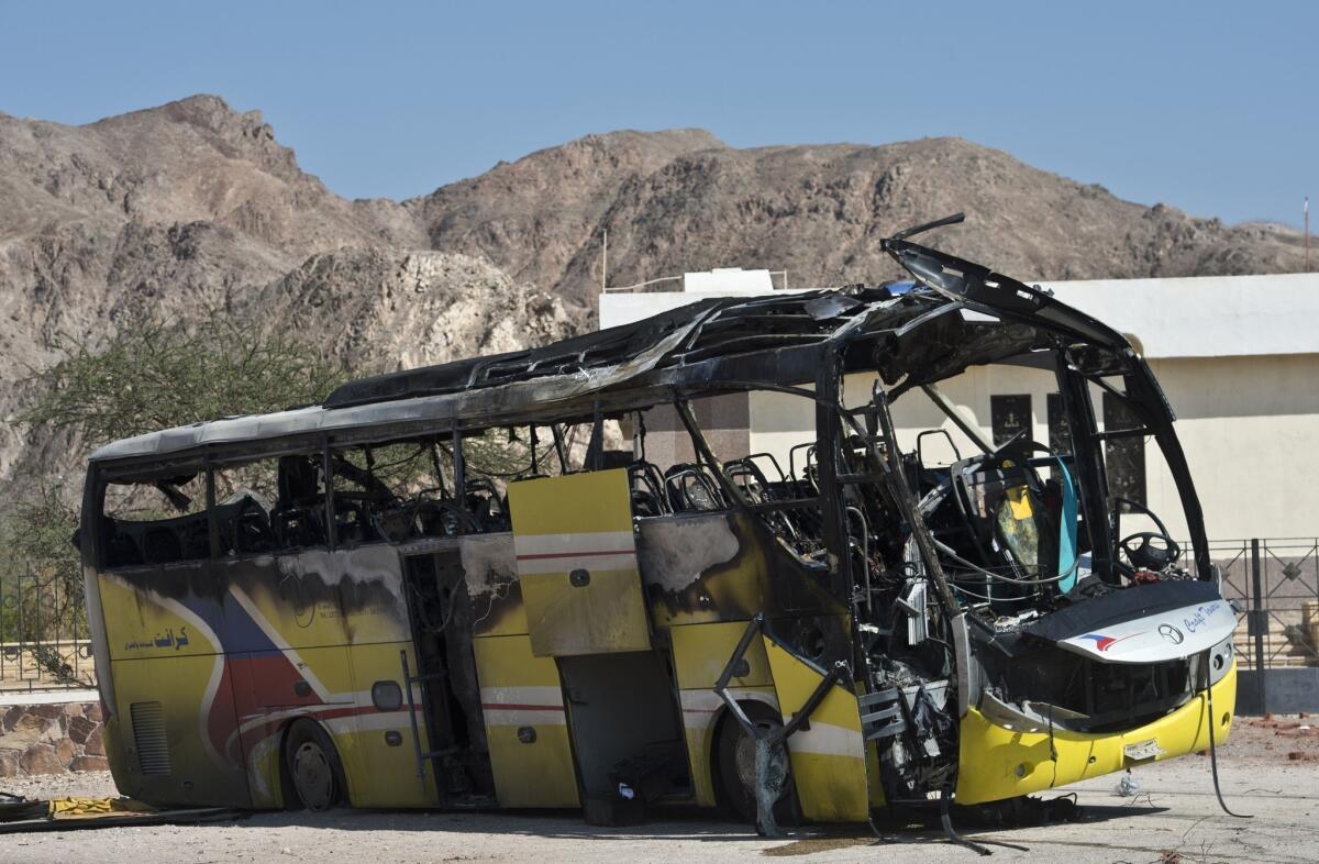 The wreckage of a tour bus that was targeted by a suicide bombing sits in the Egyptian resort town of Taba.