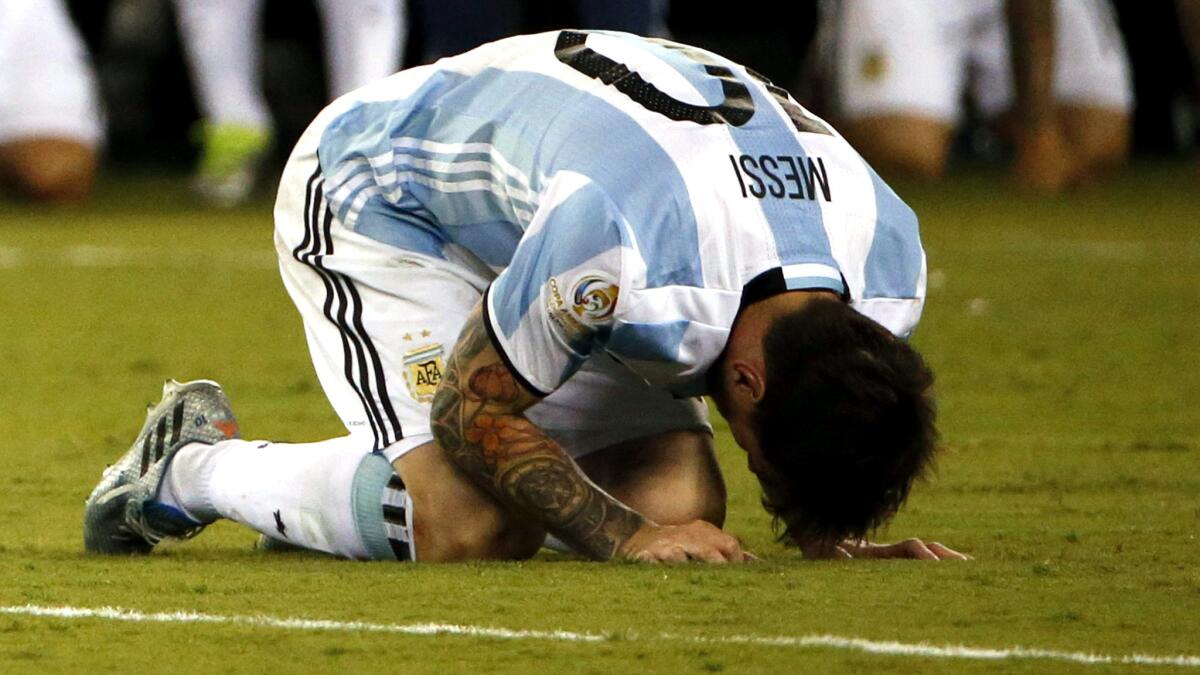 Lionel Messi crouches on the field in anguish after missing a penalty kick against Chile during Argentina's loss in the Copa American Centenario final.