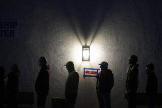 Voters stand in line outside a polling place