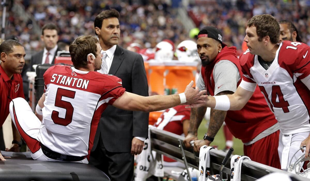 Cardinals quarterback Drew Stanton talks with reserve quarterback Ryan Lindley after being injured during the second half of the game against the Rams on Thursday night.