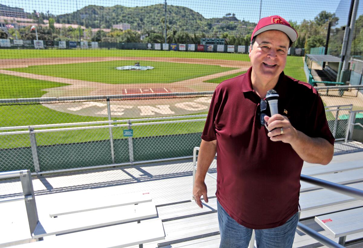 Area sports announcer Spiro Psaltis poses with a microphone at an empty Stengel Field in Glendale on Thursday, April 16, 2020.