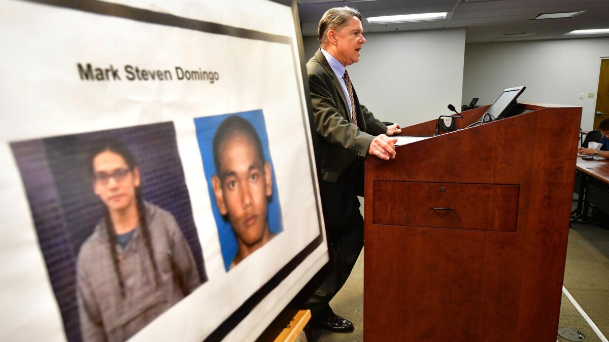 Thom Mrozek of the U.S. attorney’s office in Los Angeles briefs the media beside photographs of suspect Mark Steven Domingo, who was arrested in connection with an alleged terror plot.