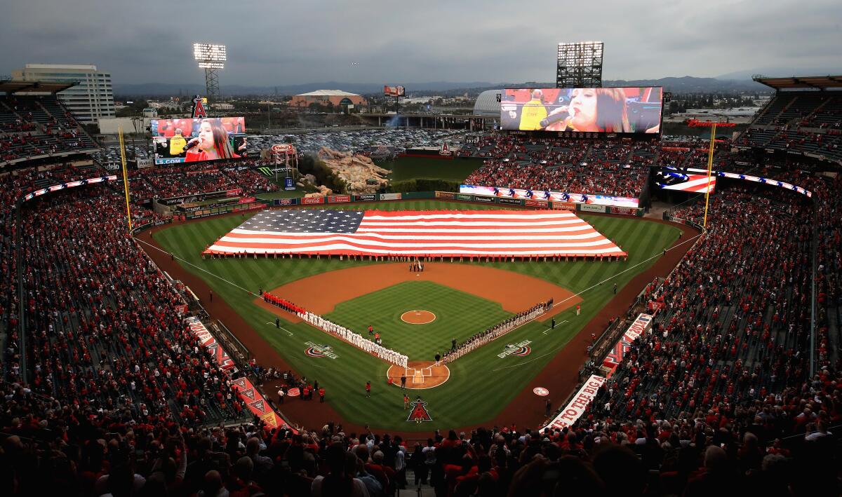 A large American flag is unfurled on the field at Angel Stadium before the team's home opener against the Cleveland Indians in April 2018.