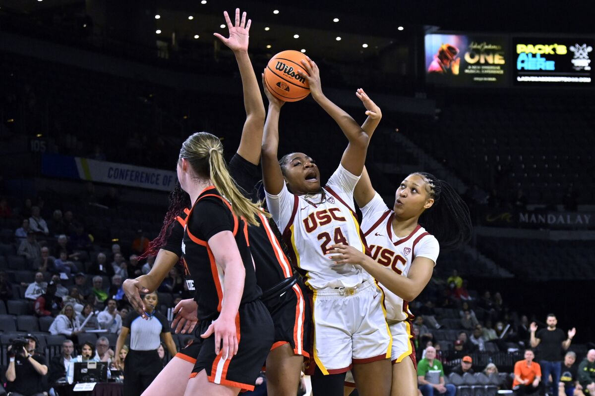 USC guard Okako Adika grabs a rebound against Oregon State