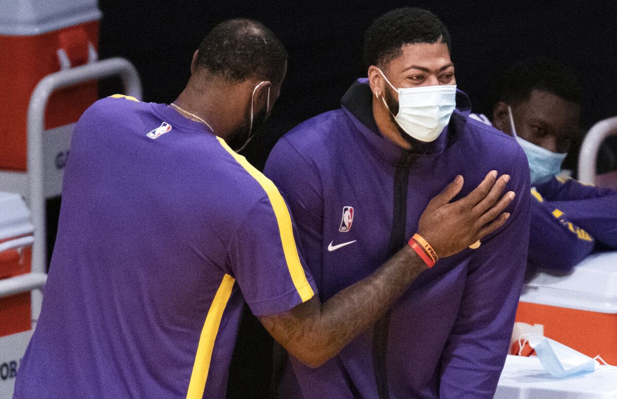 Lakers forward LeBron James, left, and forward Anthony Davis joke around during Friday's preseason game.