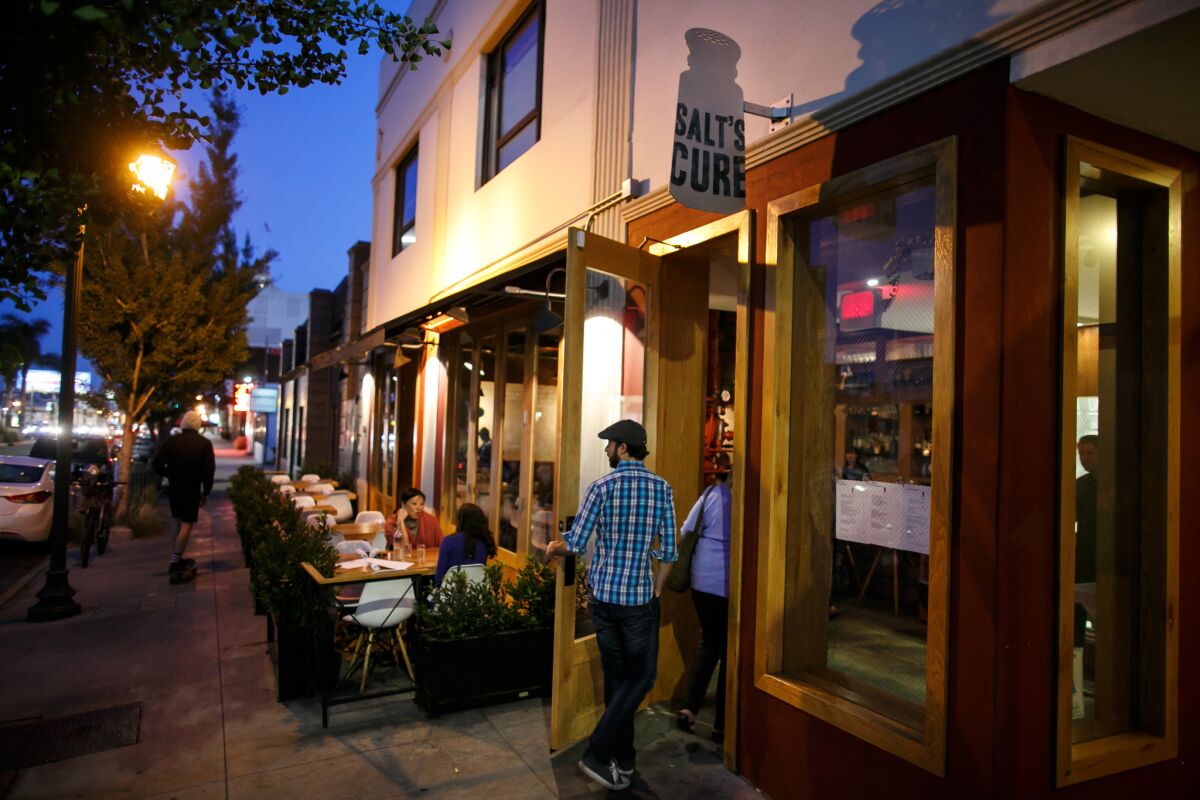 Patrons enter Salt's Cure restaurant at its new location on North Highland Avenue in Los Angeles.