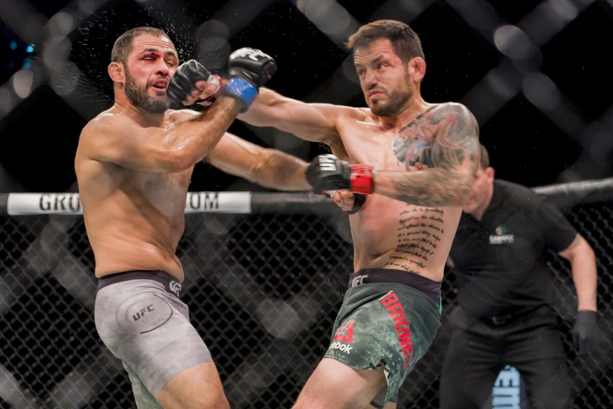 Henry Briones, right, battles Frankie Saenz during a UFC bantamweight fight in Chile in May 2018. Briones was a hockey player before fighting in mixed martial arts.