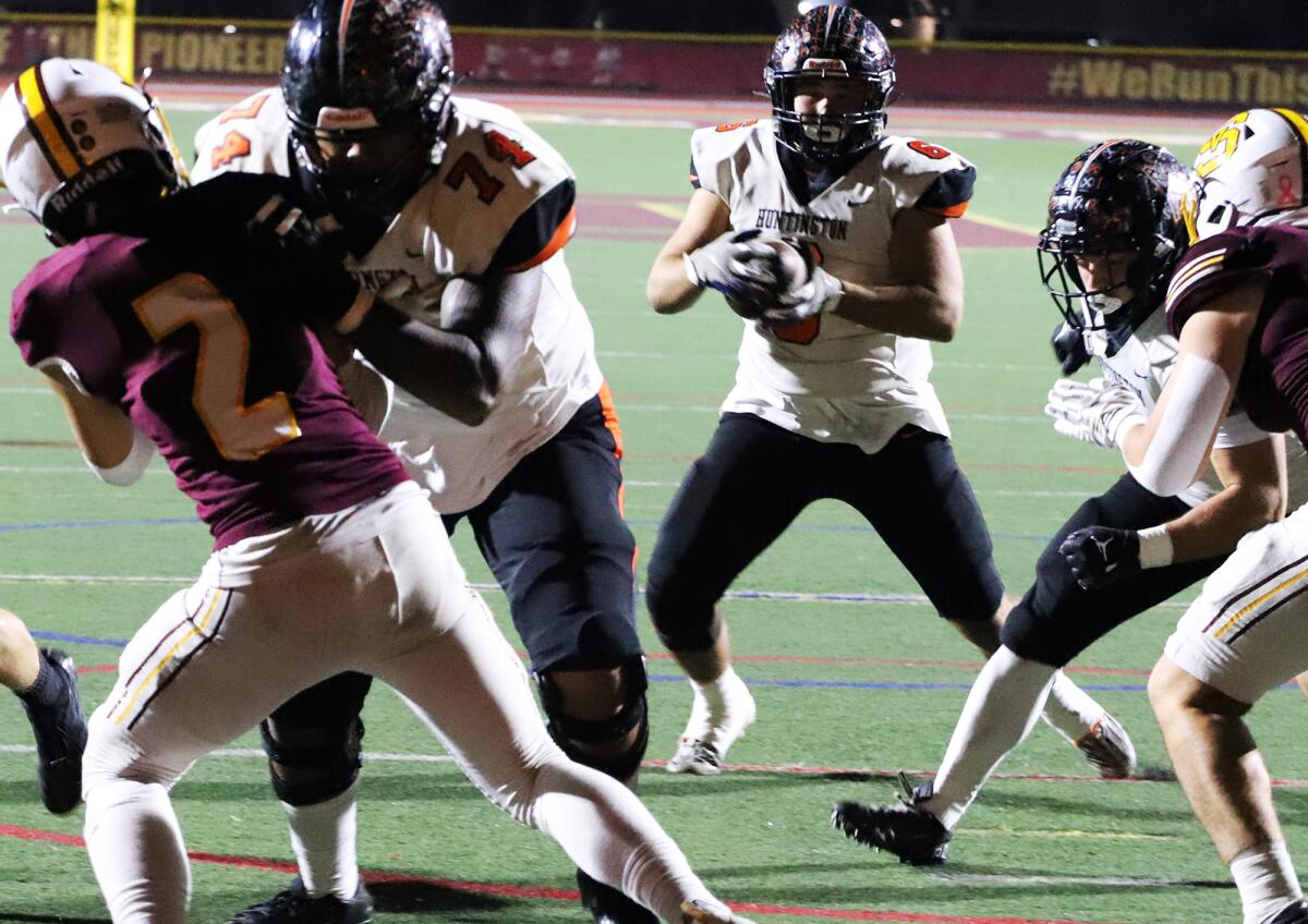 Huntington Beach's Justin Tauanuu (74) blocks for Jaxson Brown (6) for a two-point conversion against Simi Valley.