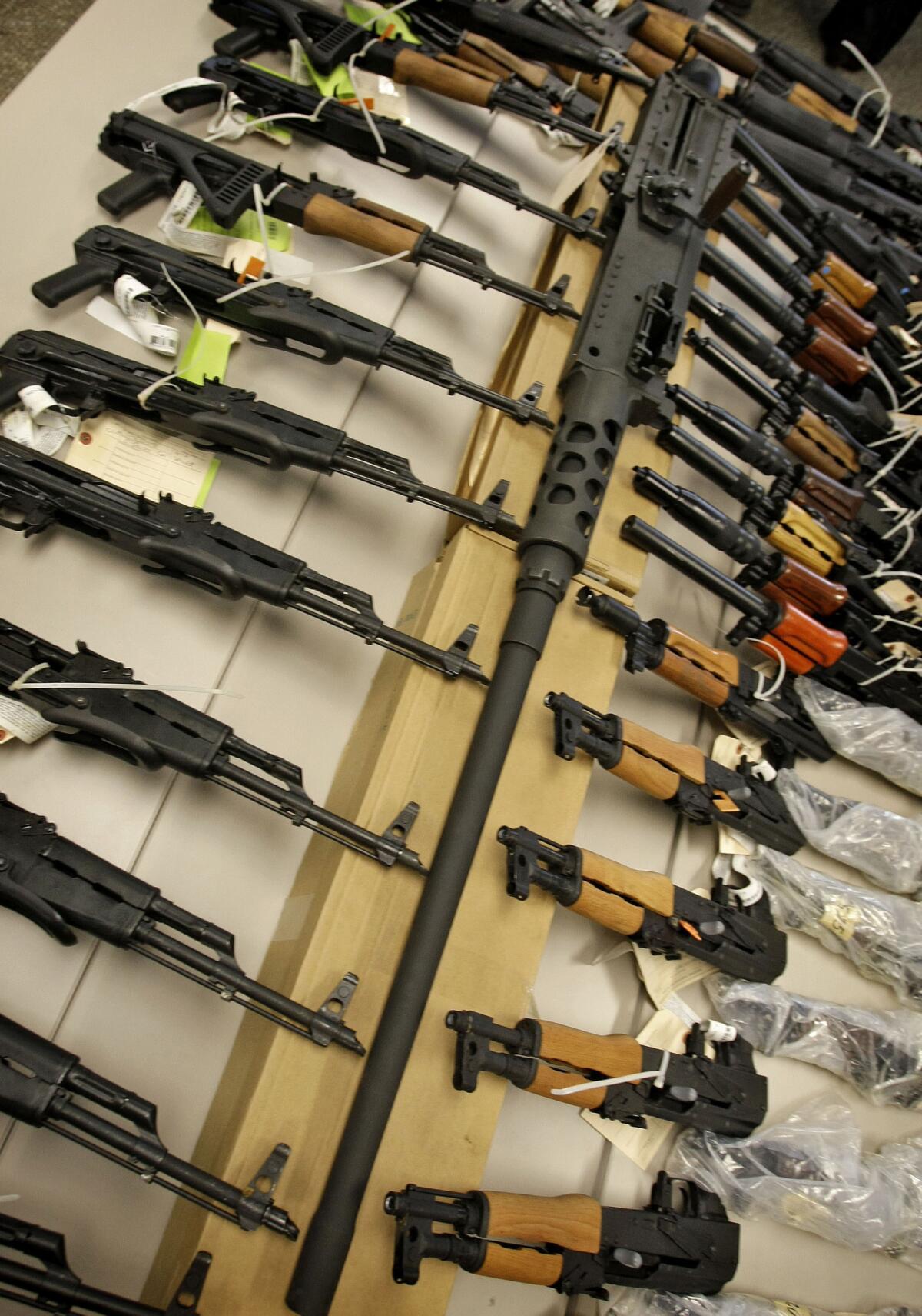 A cache of seized weapons displayed at a news conference in Phoenix.