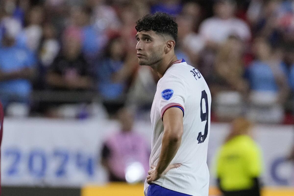 U.S. forward Ricardo Pepi stands on the field after losing to Uruguay on Monday.