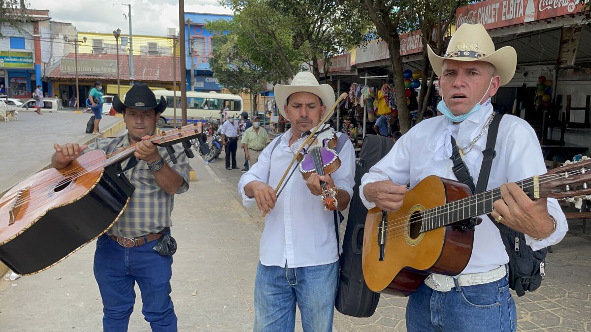 Roving musicians offer their services in the central park of Sensuntepeque, Cabañas.