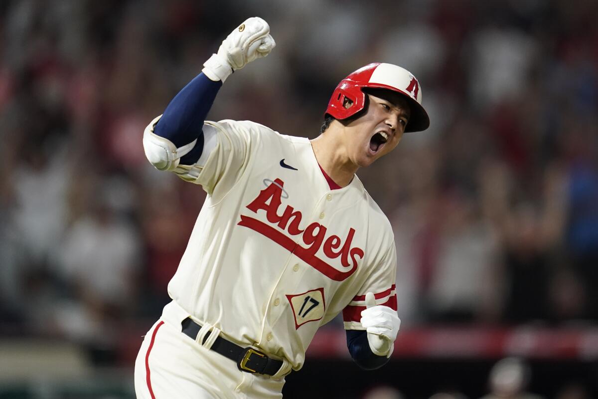 Angels designated hitter Shohei Ohtani reacts as he runs the bases after hitting a home run.