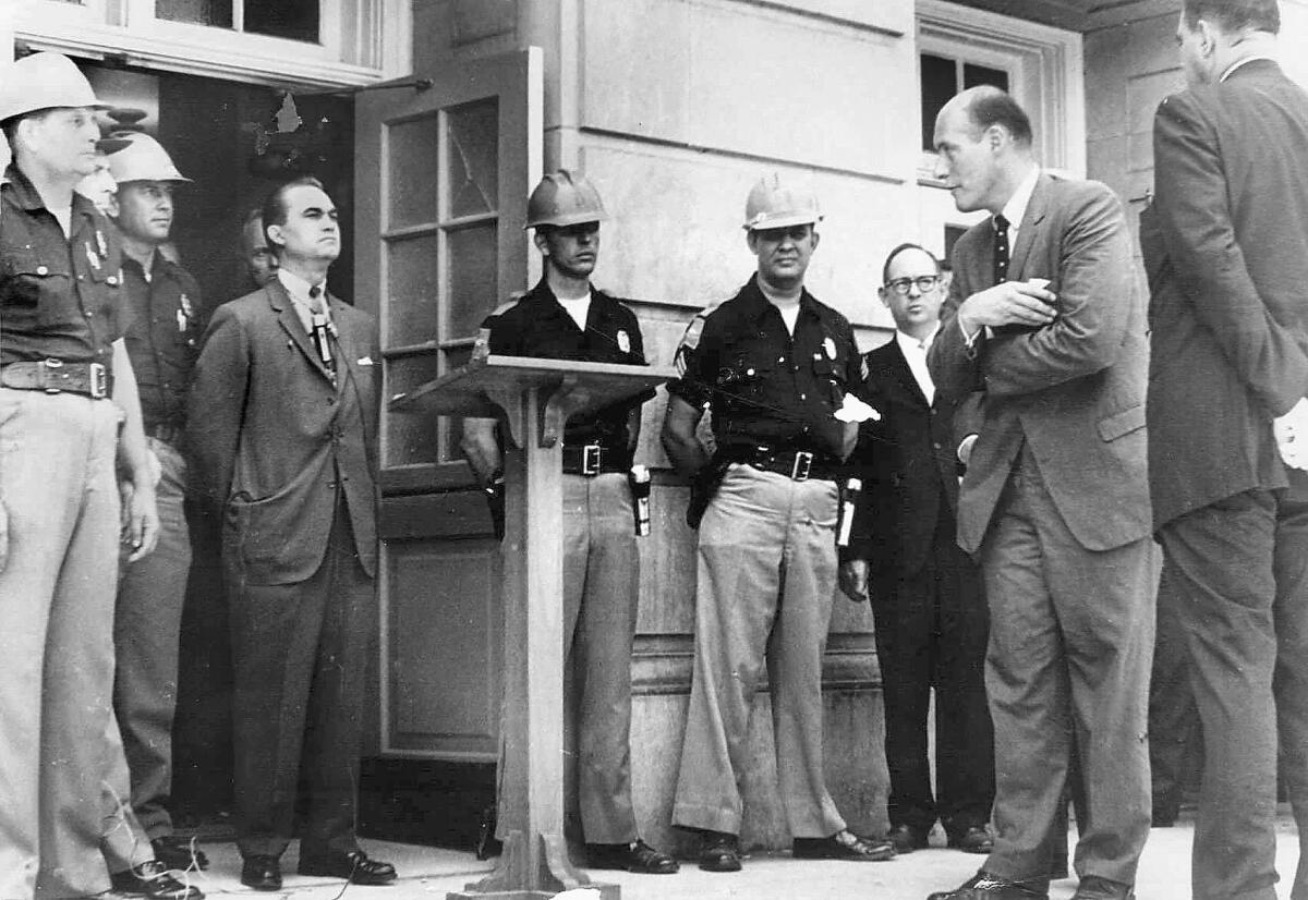 In 1963, Alabama Gov. George Wallace, wearing suit at left, tried to block the admission of two black students at the University of Alabama.