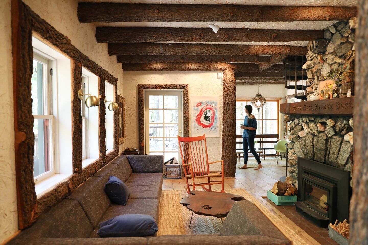 A Hans Wegner rocker finds a cozy home in front of a granite-covered fireplace.