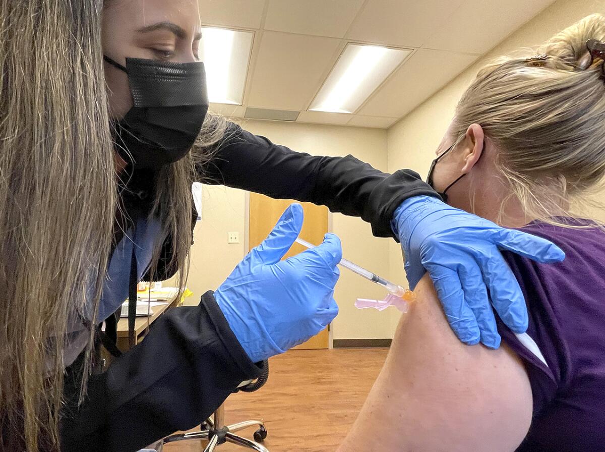 nurse Jennifer Ulloa administers a COVID-19 vaccine Tuesday, July 27, 2021, at the County's vaccination clinic in Whispering Pines, Calif. (Elias Funez/The Union via AP)