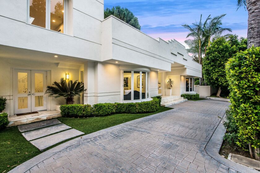The Beverly Hills home of fashion designer Dina Bar-El features a sleek modern floor plan, high ceilings and new designer wood floors.