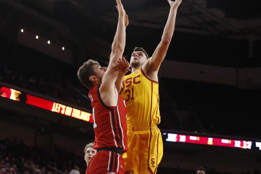 LOS ANGELES, CALIF. -- THURSDAY, JANUARY 30, 2020: USC Trojans forward Nick Rakocevic (31) scores a basket guarded by Utah Utes forward Riley Battin (21) in the first half at the Galen Center in Los Angeles, Calif., on Jan. 30, 2020. (Gary Coronado / Los Angeles Times)