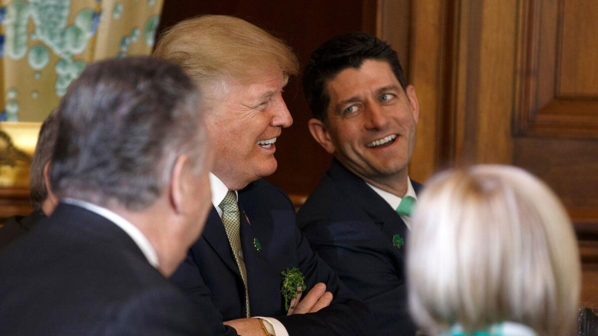President Trump laughs with US Speaker of the House Paul Ryan at the United States Capitol in Washington on March 15.