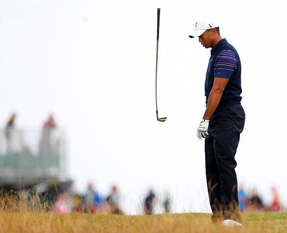 Tiger Woods throws his club down after playing a shot on the 10th hole during the first round of the British Open at Turnberry Golf Club in Scotland.