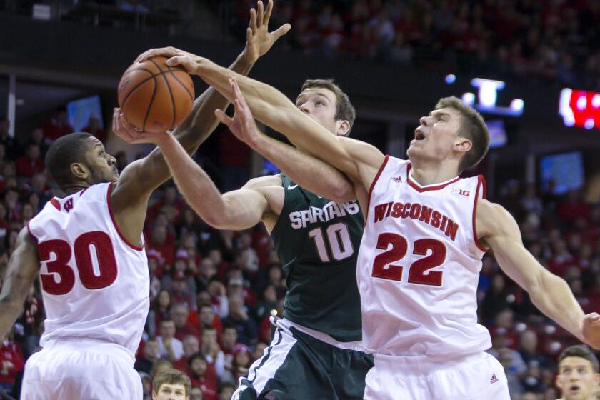 Wisconsin's Ethan Happ (22) blocks a shot by Michigan State's Matt Costello (10) during the first half Sunday.