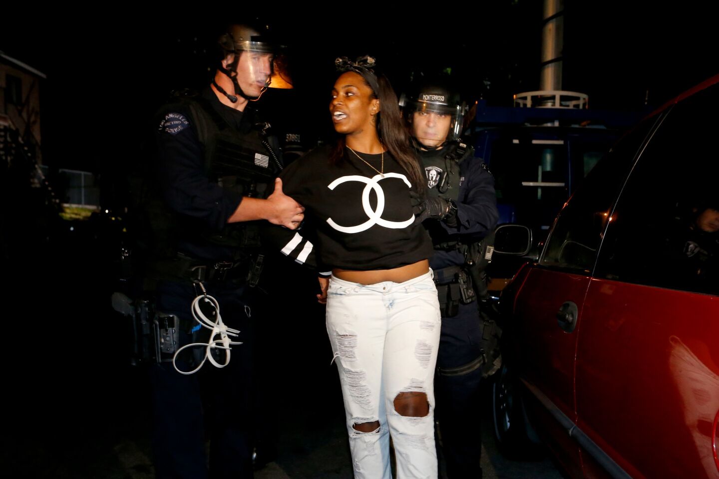 An activist is arrested by LAPD after they gave orders to clear the area along 107th Street. Protesters were rallying after police shot an 18-year-old in South L.A.