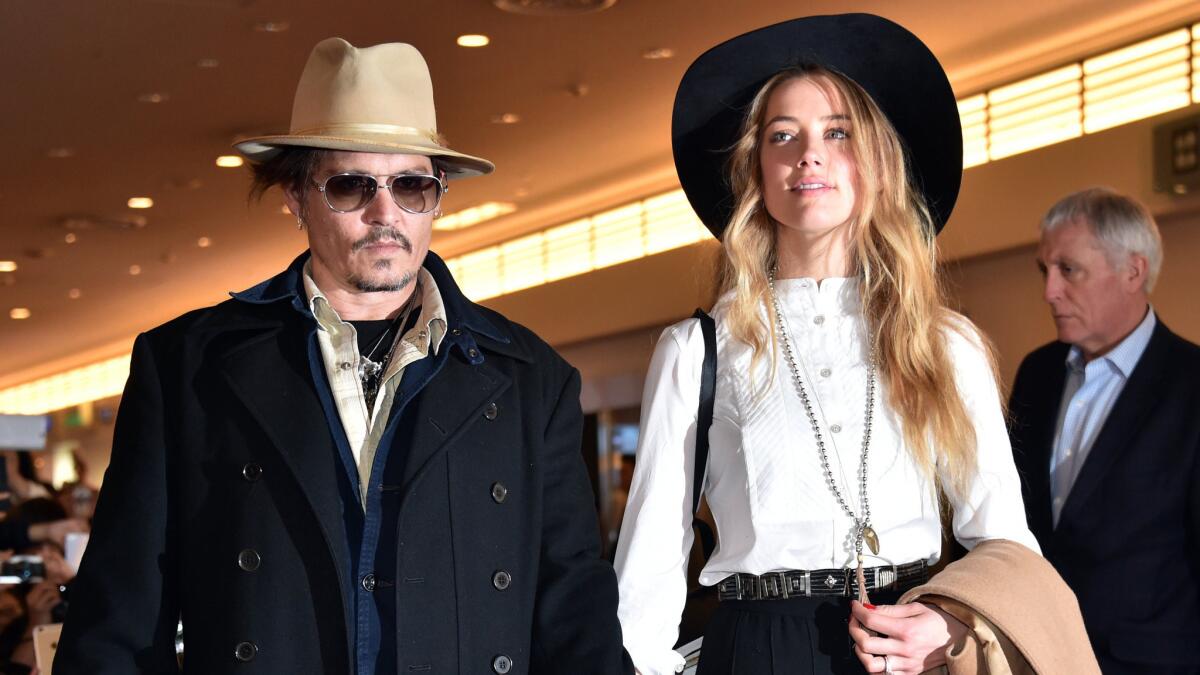 Johnny Depp and Amber Heard arrive at Tokyo International Airport in January. It was their jaunt to Australia in April, with dogs in tow, that has her in a jam.